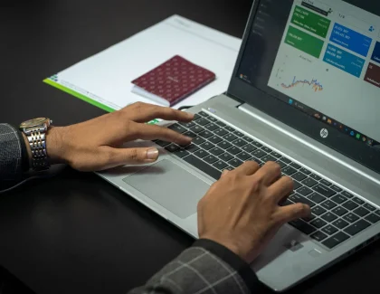 Personne tapant sur un clavier avec des tableaux de bord analytiques et des réponses d'IA affichées à l'écran